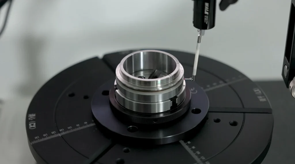Roundness measuring probe checking a bearing component on a rotary measuring table